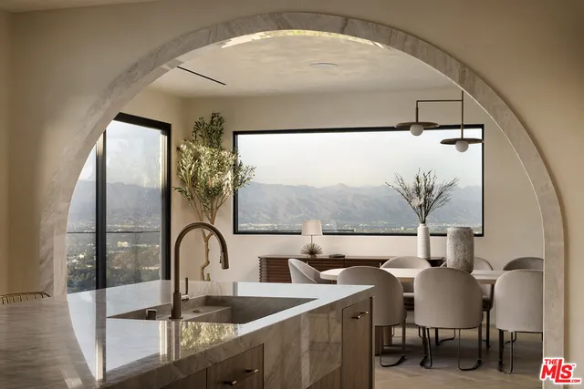a kitchen with stainless steel appliances granite countertop a sink and a microwave
