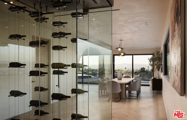 a dining room with furniture and a floor to ceiling window