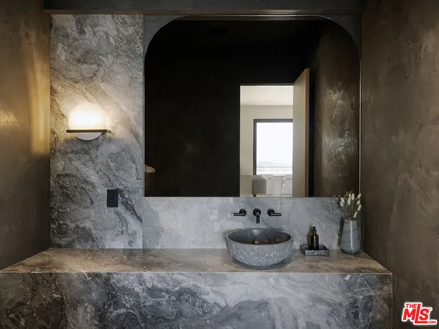 a bathroom with a sink and a mirror