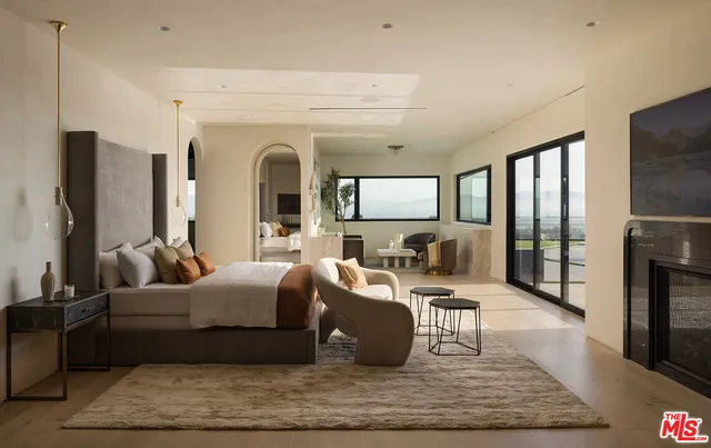a bathroom with a tub sink shower and mirror
