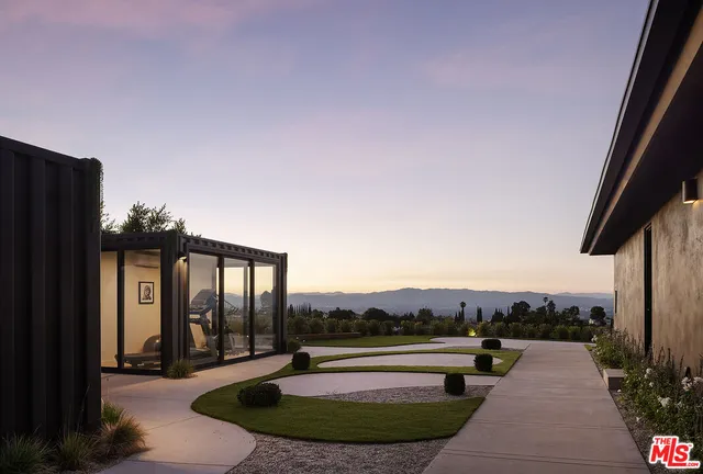 a view of a chairs and table in backyard