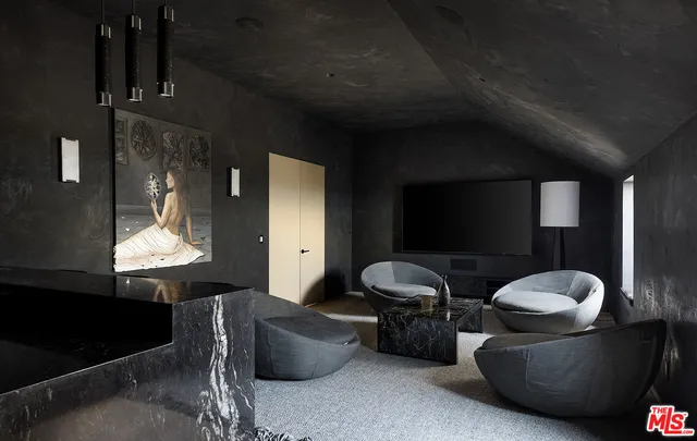 a living room with furniture and a lamp