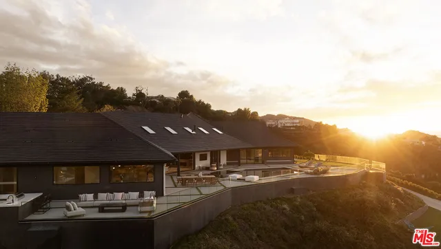 a view of a roof deck with couches and potted plants