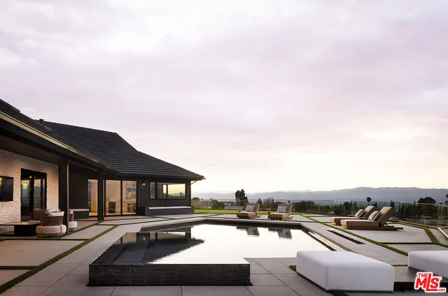 a view of a swimming pool with seating area