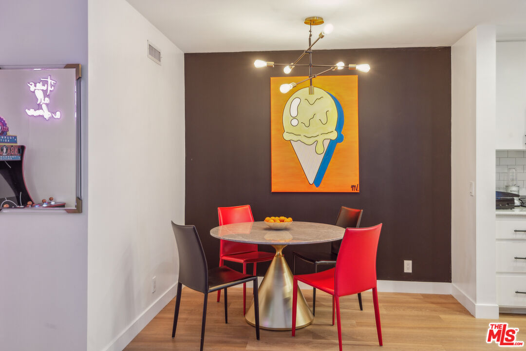7250 Franklin Avenue, Unit 512 Los Angeles, CA 90046 - Photo 16 of 28 a view of a dining room with furniture and wooden floor