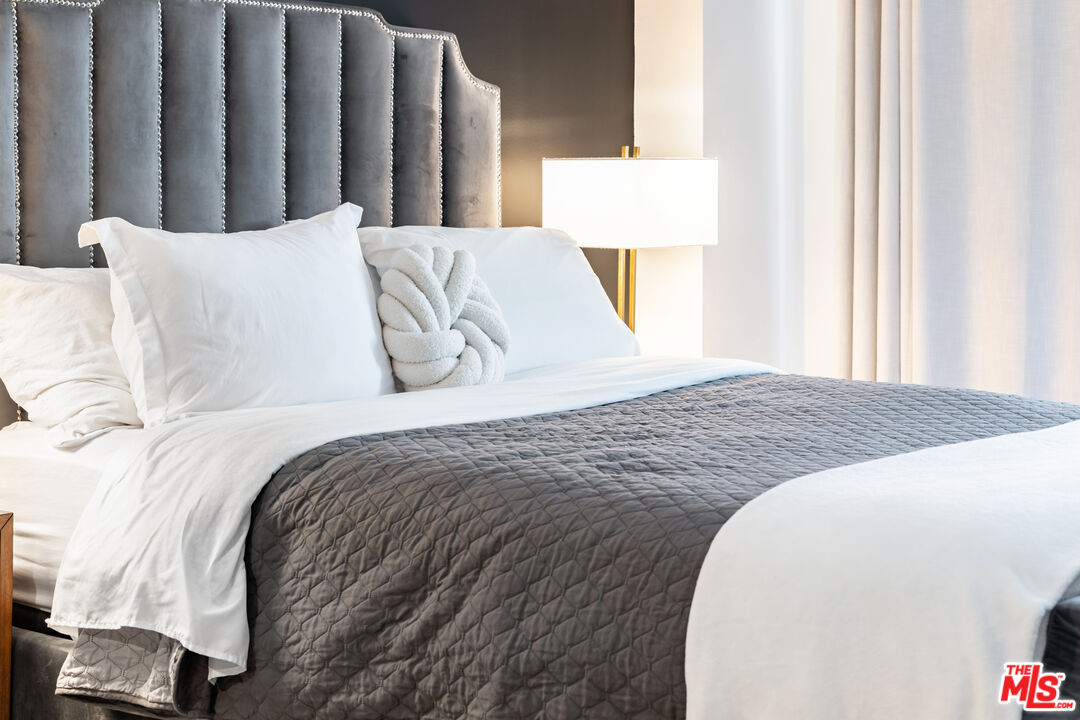 7250 Franklin Avenue, Unit 512 Los Angeles, CA 90046 - Photo 20 of 28 a large bed sitting in a bedroom next to a window