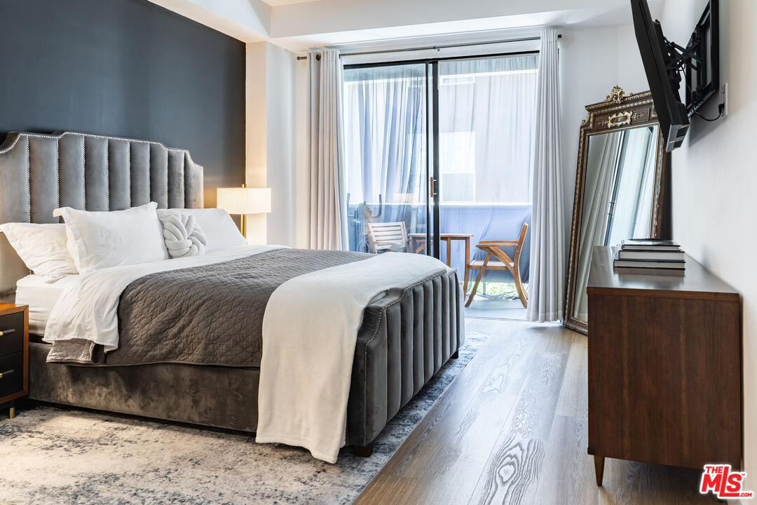 7250 Franklin Avenue, Unit 512 Los Angeles, CA 90046 - Photo 2 of 28 a bedroom with a bed next to a large window