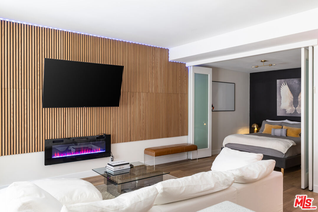 7250 Franklin Avenue, Unit 512 Los Angeles, CA 90046 - Photo 7 of 28 a living room with a flat screen tv and a couch