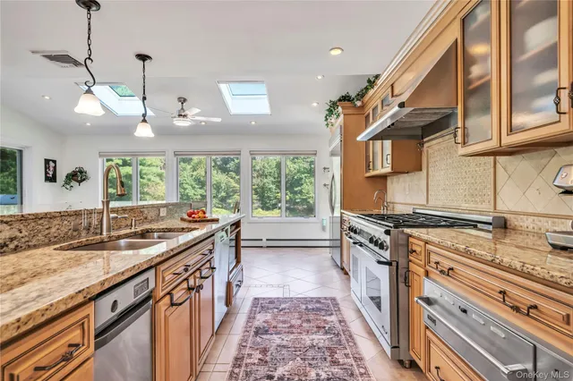 a kitchen with stainless steel appliances granite countertop a stove and a sink