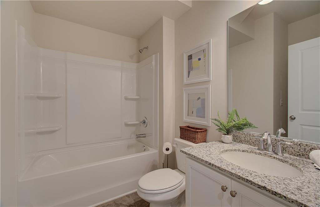 477 Collier Mls Road Lawrenceville, GA 30045 - Photo 11 of 40 a bathroom with a granite countertop sink toilet and shower