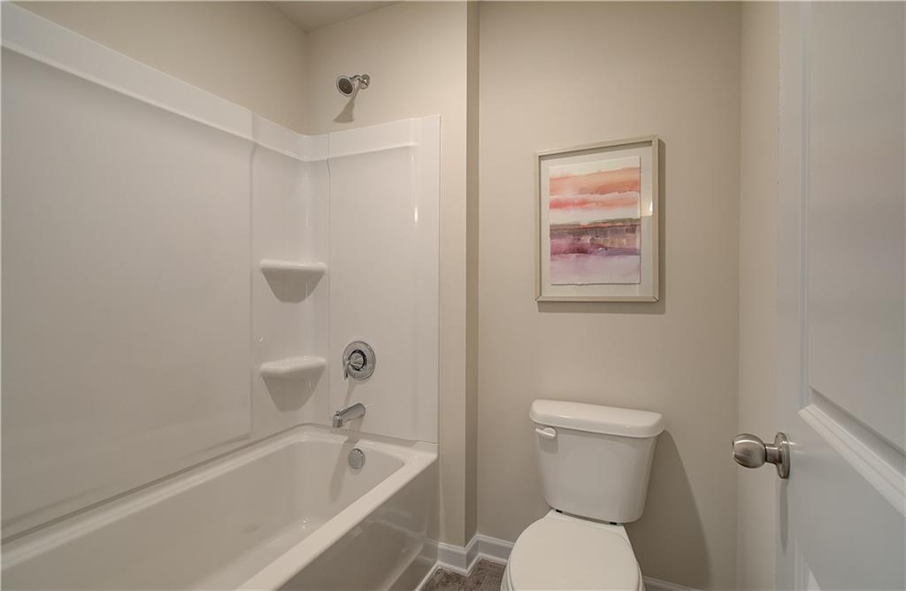 477 Collier Mls Road Lawrenceville, GA 30045 - Photo 27 of 40 a white toilet sitting next to a bath tub
