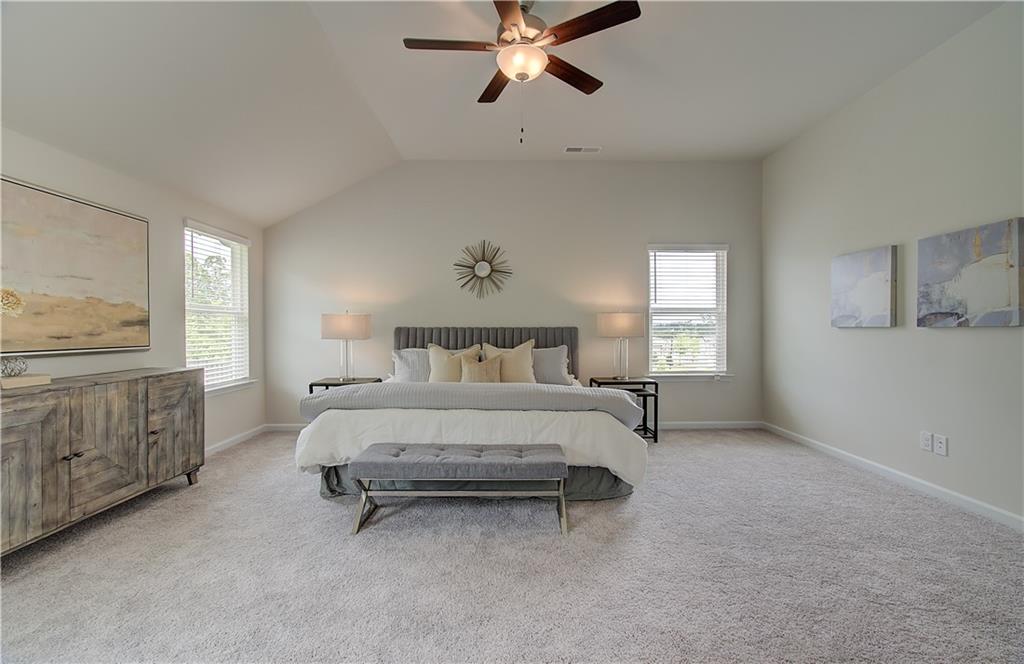 477 Collier Mls Road Lawrenceville, GA 30045 - Photo 32 of 40 a spacious bedroom with a bed and a cabinets