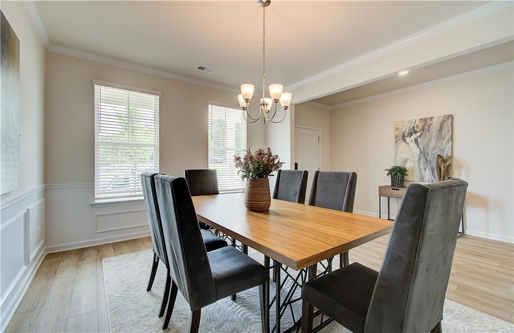 477 Collier Mls Road Lawrenceville, GA 30045 - Photo 8 of 40 a view of a dining room with furniture window and wooden floor