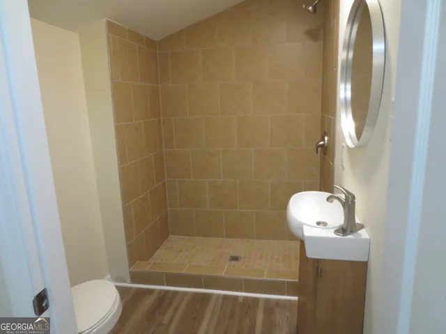 a bathroom with a shower and toilet