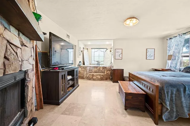 a bedroom with furniture and a flat screen tv