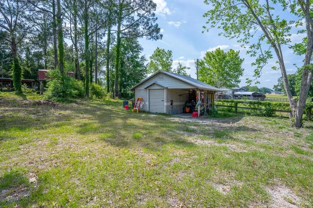 a view of a house with a yard and sitting area