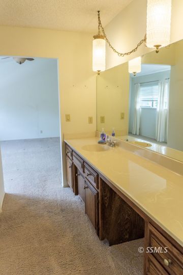 924 Scott Street Ridgecrest, CA 93555 - Photo 17 of 26 a bathroom with a sink and a mirror