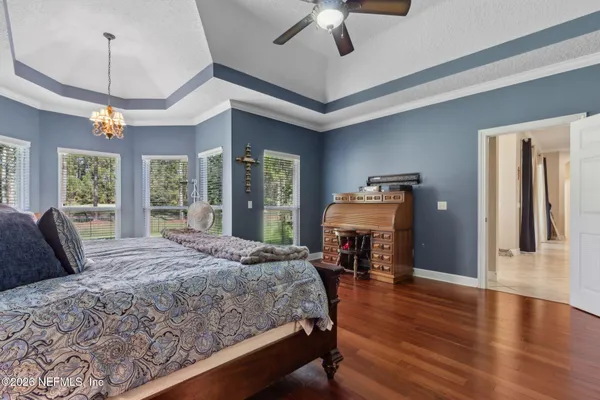a bedroom with a bed and a chandelier