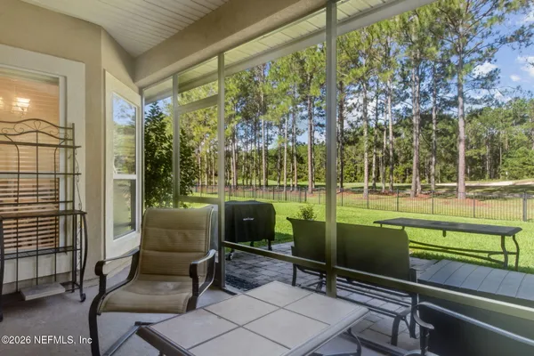 a view of backyard with outdoor seating and green space