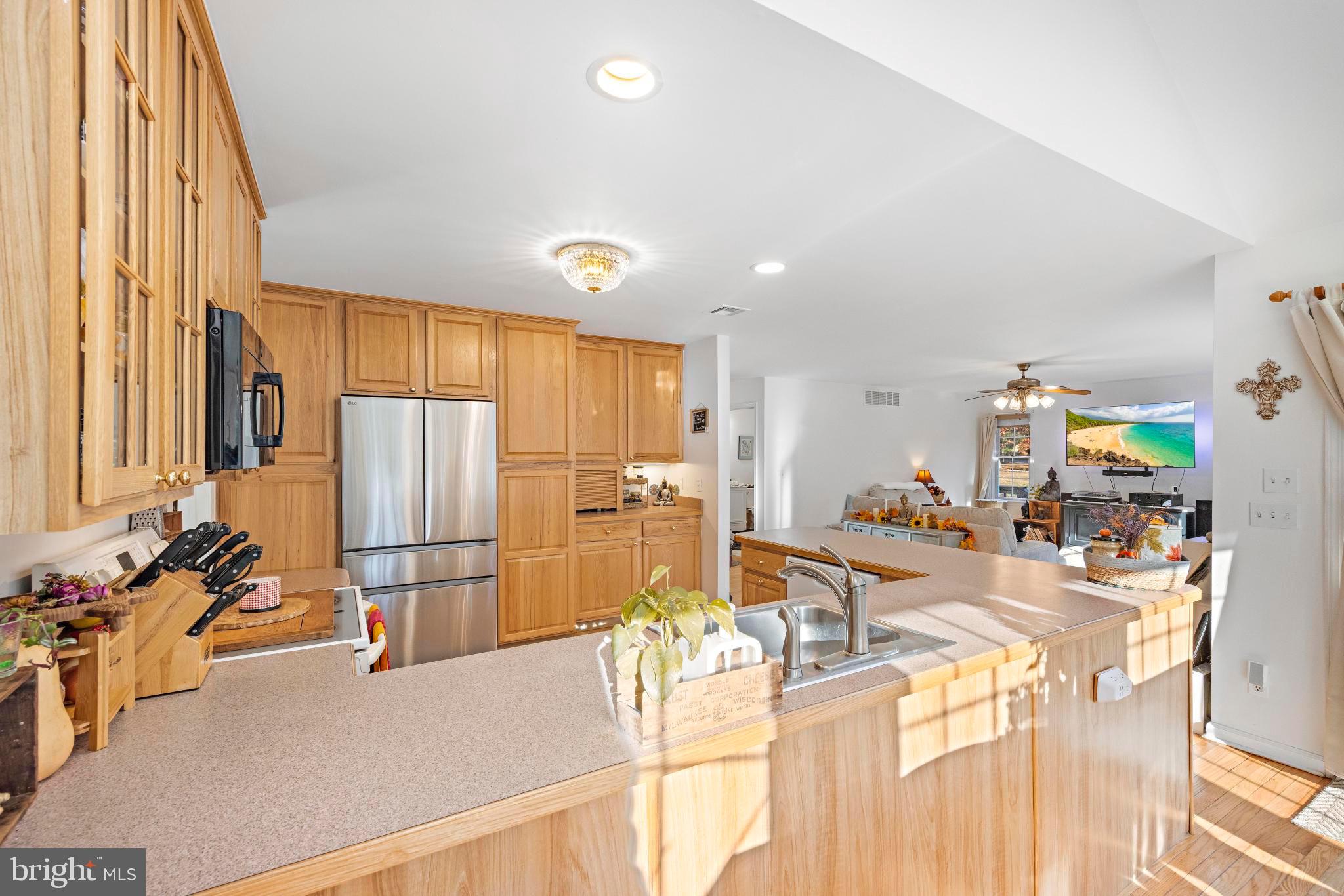 3 Hay Road Tuckerton, NJ 08087 - Photo 23 of 50 a kitchen with stainless steel appliances a dining table chairs and a refrigerator