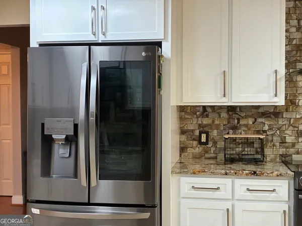 a bed sitting in a bedroom next to a lamp