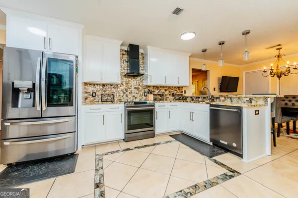 a bed sitting in a bedroom next to a window with wooden floor
