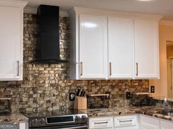 a bedroom with a bed and a lamp on table