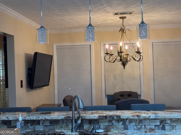 a bedroom with a bed and a mirror on dresser