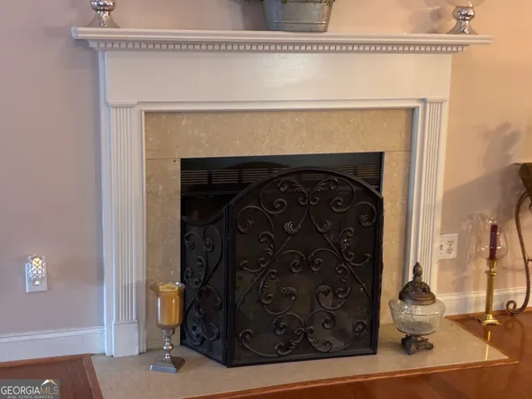 a living room with a fireplace and a flat screen tv