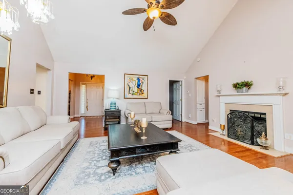 a living room with furniture and floor to ceiling windows