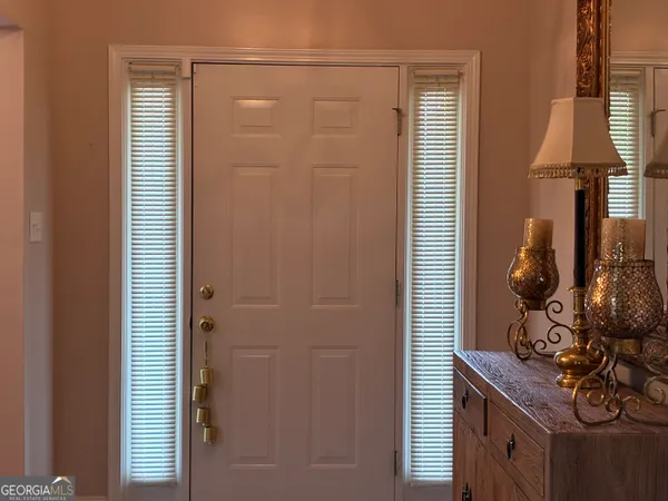 a bathroom with a light fixture and a window