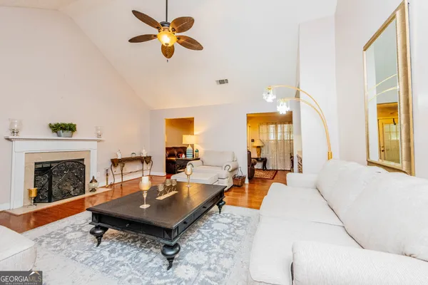 a view of a swimming pool with lawn chairs under an umbrella