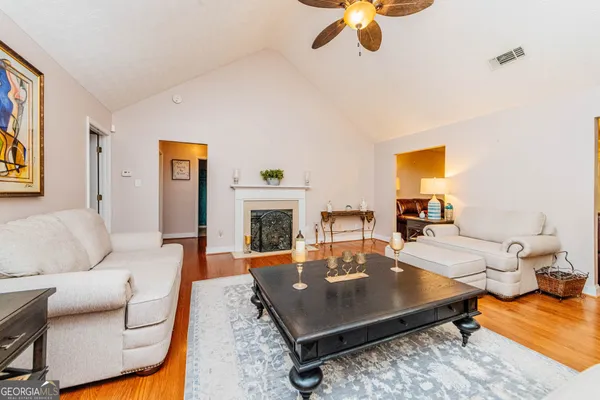 a backyard of a house with dining table and chairs