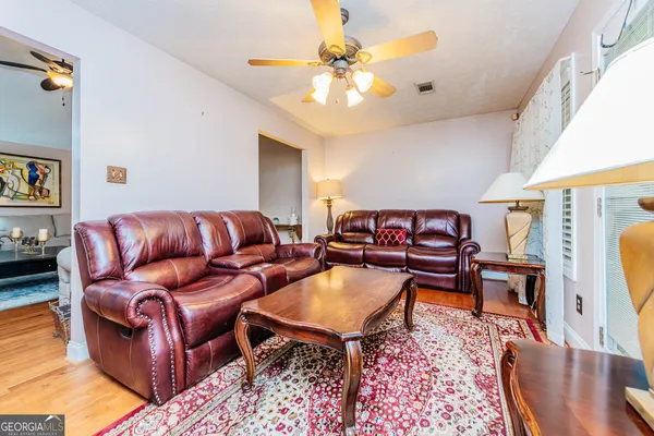 a view of a house with a yard table and chairs