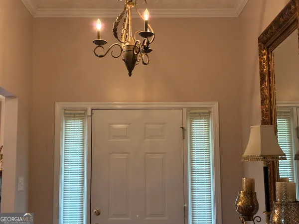 a bathroom with a granite countertop sink a mirror and shower