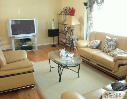 2 Meredith Road Edison, NJ 08817 - Photo 2 of 5 a living room with furniture a fireplace and a flat screen tv