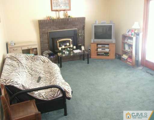 2 Meredith Road Edison, NJ 08817 - Photo 3 of 5 a living room with furniture and a fireplace