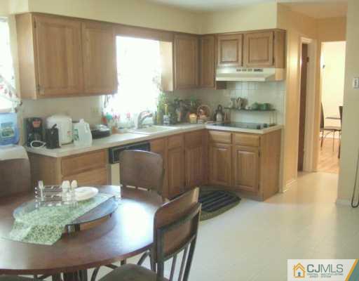 2 Meredith Road Edison, NJ 08817 - Photo 5 of 5 a kitchen with stainless steel appliances granite countertop a sink and a refrigerator
