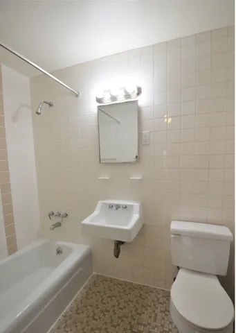 a bathroom with a toilet sink and bathtub