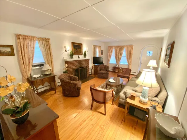 a living room with furniture fireplace and a large window