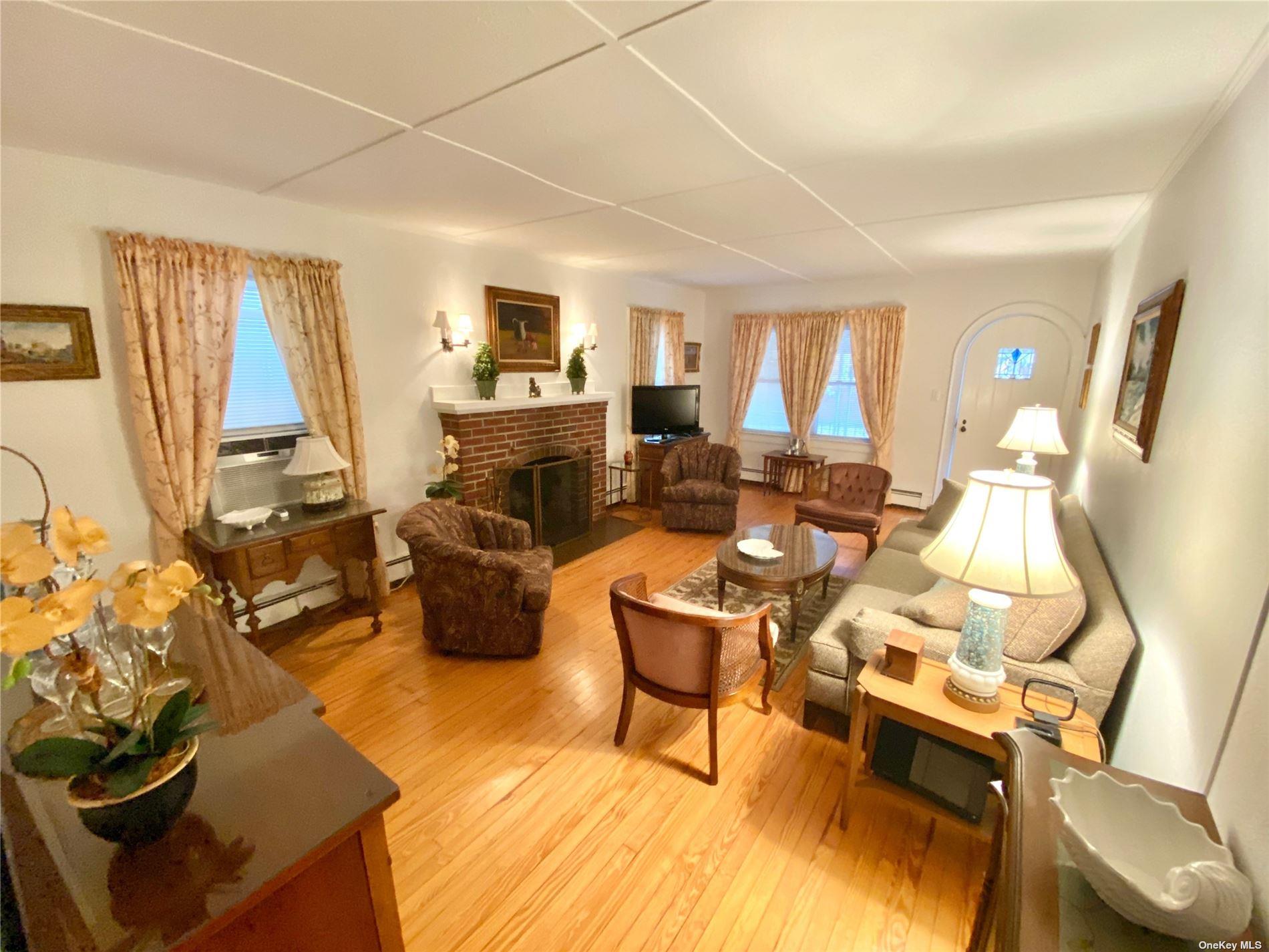 111 Inwood Avenue Point Lookout, NY 11569 - Photo 2 of 11 a living room with furniture fireplace and a large window
