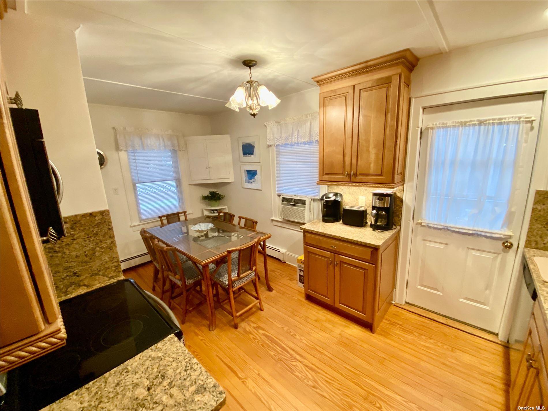 111 Inwood Avenue Point Lookout, NY 11569 - Photo 3 of 11 a kitchen with a refrigerator a stove top oven a sink and dishwasher