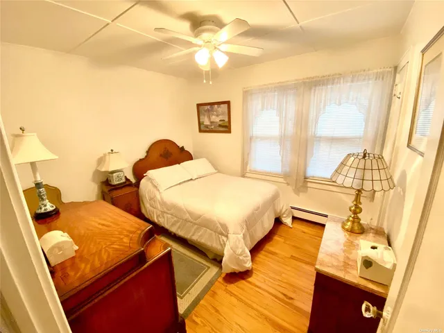 a bedroom with 2 bed and a window