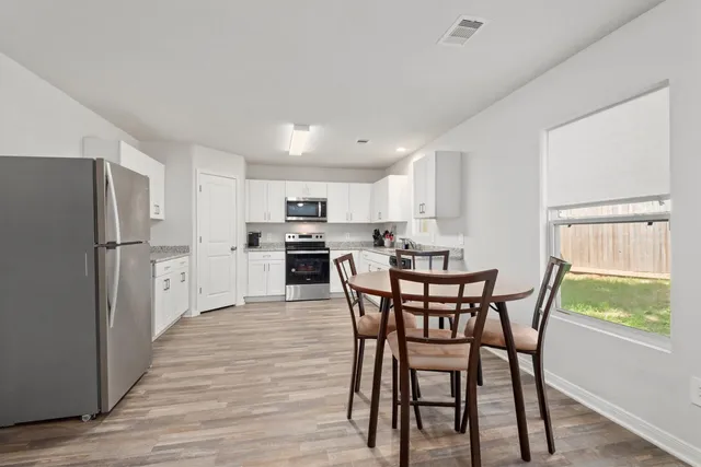 a view of a dining room with furniture window and wooden floor