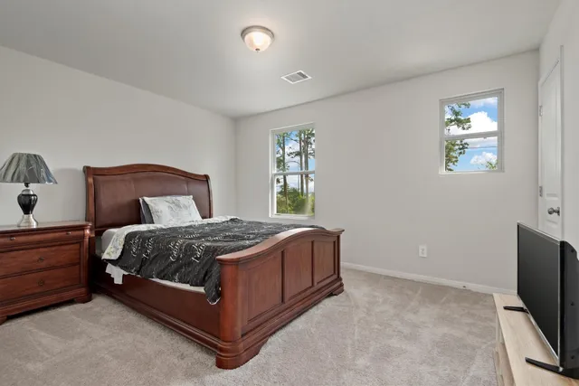 a bedroom with a bed table and window