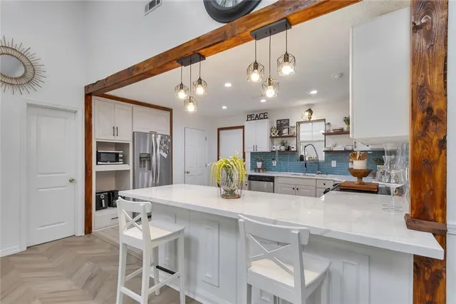 a kitchen with stainless steel appliances a sink and counter space