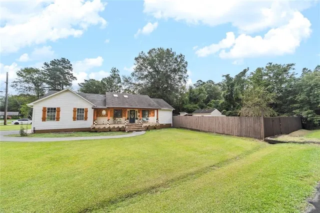 a view of a house with a yard and roof