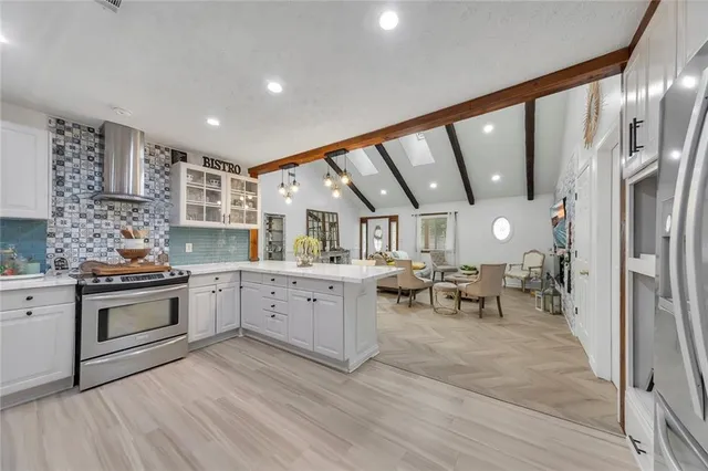 a kitchen with stainless steel appliances granite countertop a stove and a refrigerator