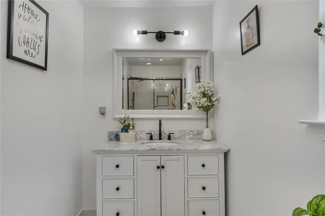 a bathroom with a shower and a sink