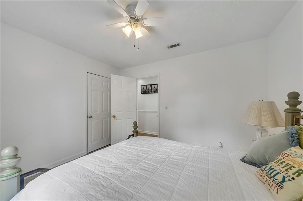 52 Glenda Drive Southwest Rome, GA 30165 - Photo 33 of 50 a bedroom with a bed and a chandelier